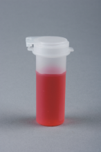 Vial with red liquid.
